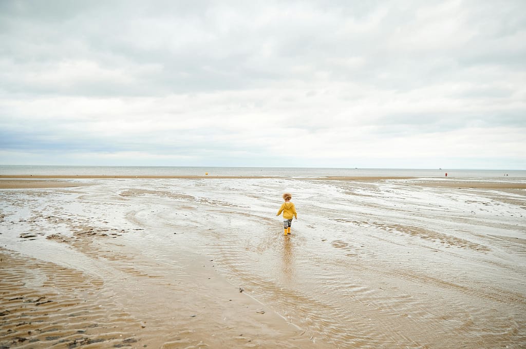 a child walking on a beach
